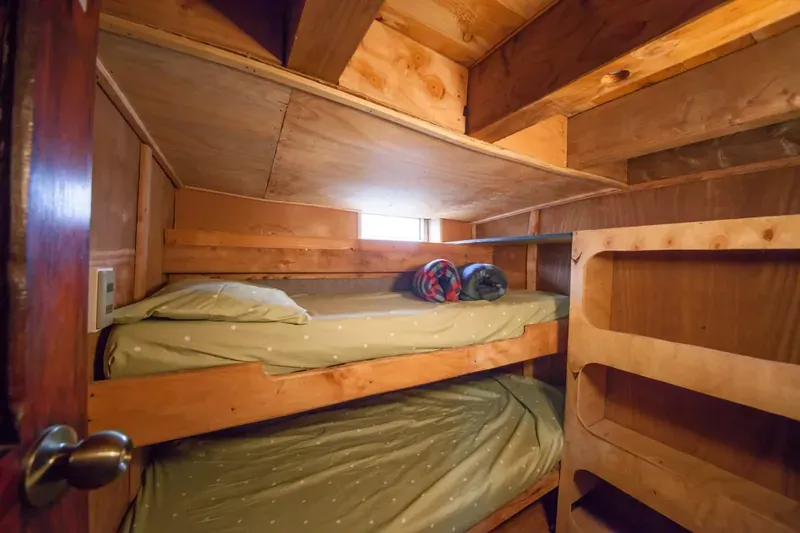 Cabin on Patagonia I: two bunk beds, wood panelling and a small window